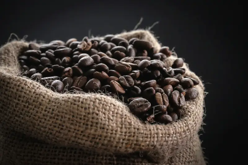 Burlap sack overflowing with roasted coffee beans