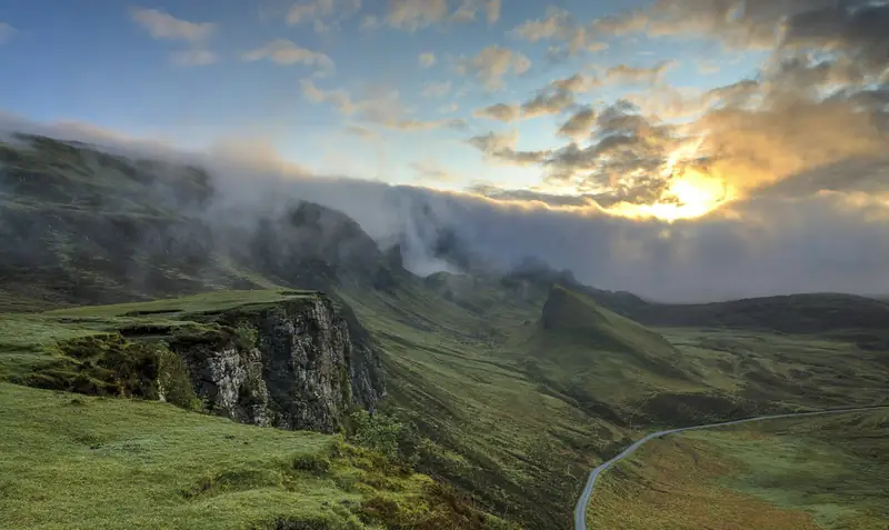 Misty green hills at sunrise