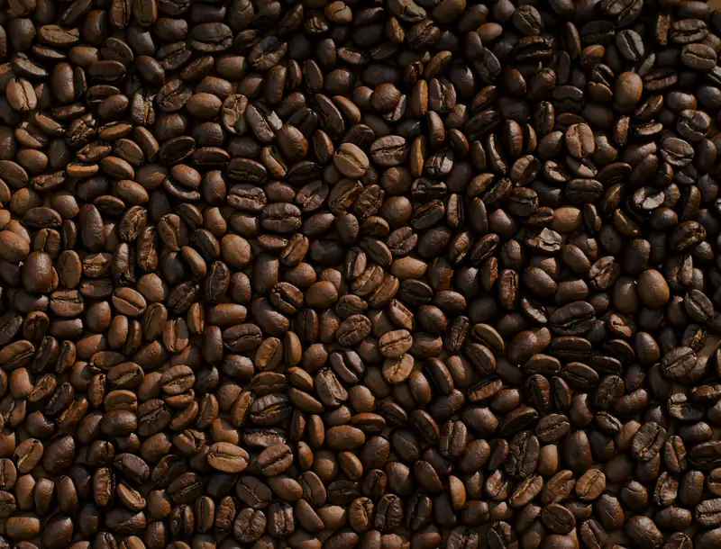 Freshly roasted dark-brown coffee beans